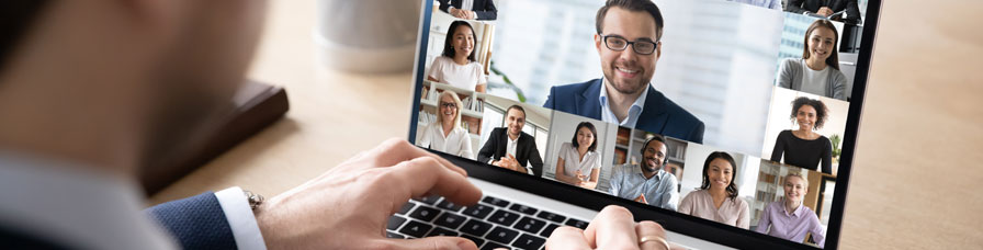 Rear view of businessman speak on web conference with diverse colleagues using laptop. Webcam, male employee talk on video call with coworkers have online meeting briefing from home.